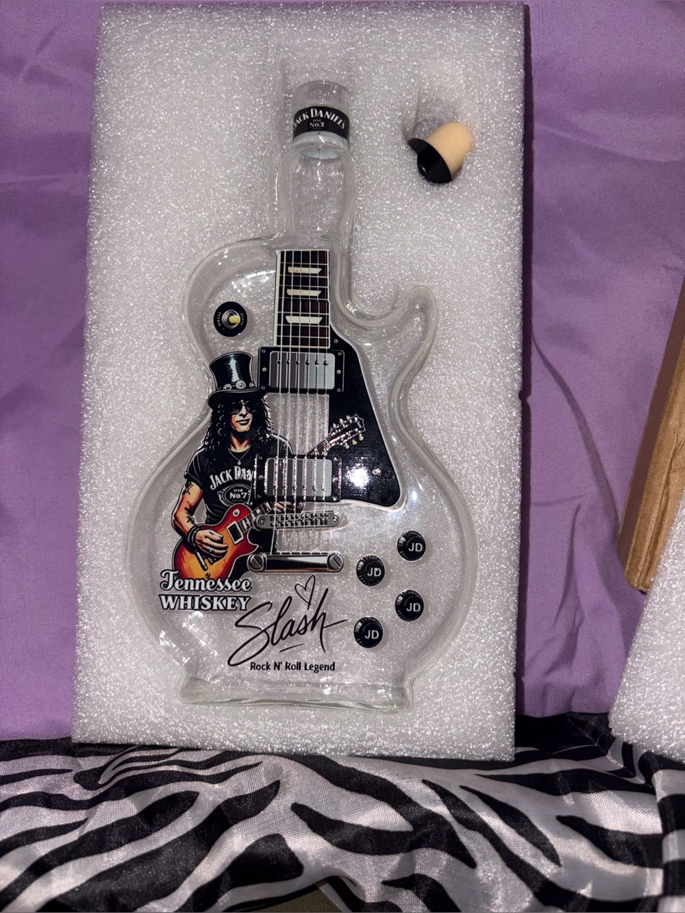 Jack Daniels Clear Guitar Bottle with Black and Red Artwork and Purple Backing
